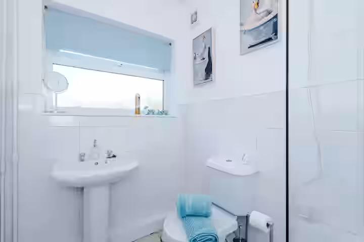 Bathroom styled with fresh towels and soft blue accents