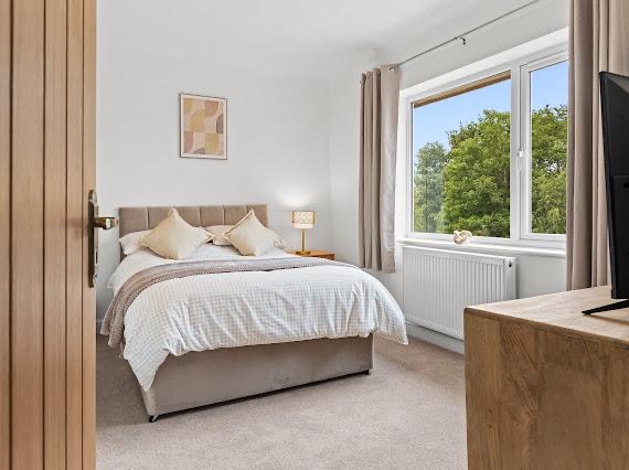 Neutral toned bedroom styled for a bright, calm feel